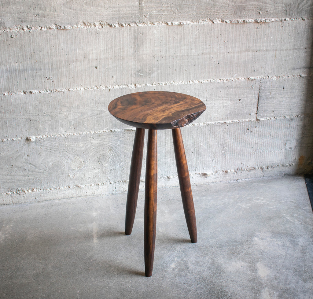 Live-edge walnut side table, angled top view showing grain detail