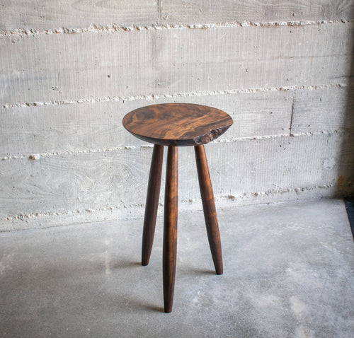 Live-edge walnut side table, angled top view showing grain detail